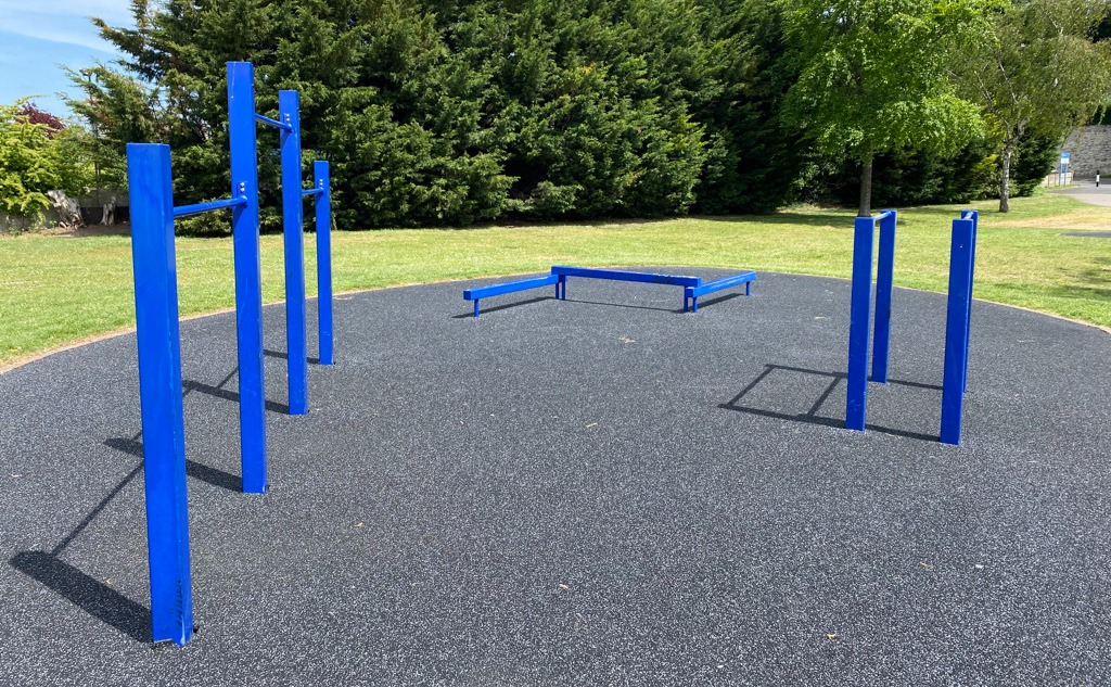 A collection of bars and supports on a rubber-chip floor in the Esplanade Gardens